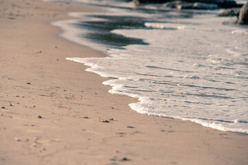 Small waves rolling onto a sandy beach
