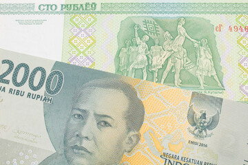 Fototapeta na wymiar A macro image of a grey two thousand Indonesian rupiah bank note paired up with a green one hundred ruble note from Belarus. Shot close up in macro.
