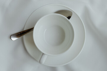 Empty Coffee Cup On White Fabric.