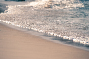Small waves rolling onto a sandy beach