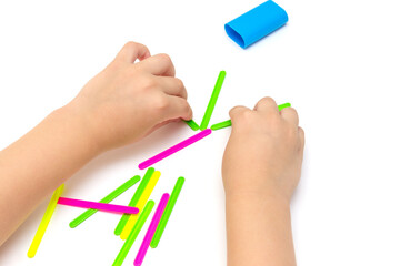 Child in kindergarten, school plays with counting sticks, learn to count, play, children's hands...