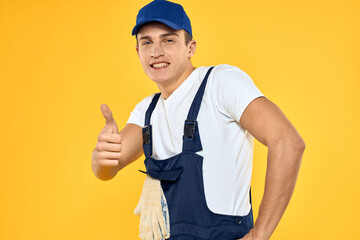 Man in working uniform emotions rendering service delivery service yellow background