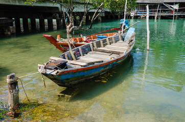 Fototapeta na wymiar The Fisherman's Boats is Moored on the Clear Water at Southern Province of Thailand.