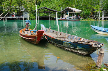 Fototapeta na wymiar The Fisherman's Boats is Moored on the Clear Water at Southern Province of Thailand.