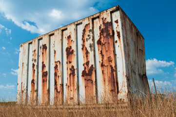 Rusted Shipping Container Abandoned in Field