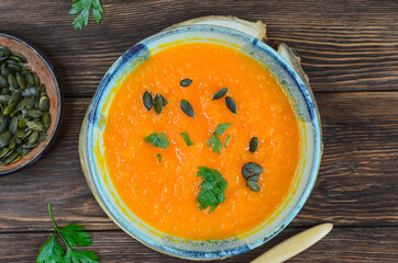 Autumn delicious food, hearty pumpkin soup top view, healthy nutrition on autumn dinner, the concept of thanksgiving day