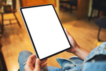 Mockup image of a woman holding digital tablet with blank white desktop screen