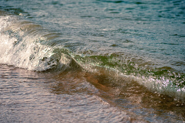 Small waves rolling onto a sandy beach