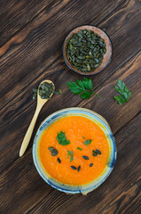 Autumn delicious healthy food, hearty pumpkin soup top view, healthy nutrition on autumn dinner,...