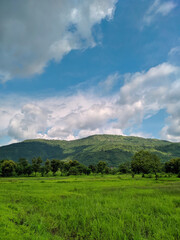 Fototapeta na wymiar clouds over the mountains of kokan. Beautiful Landscape in maharashtra with greenery of monsoon.