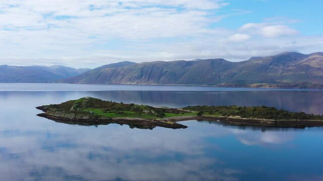 aerial view of balnagowan island and loch linnhe near fort william and ben nevis during a calm clear blue day in autumn in the argyll region of the highlands of scotland