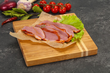 Sliced smoked duck breast served salad