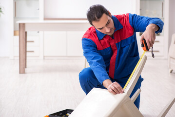 Young male carpenter working indoors