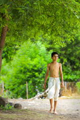 a priest child walking at forest