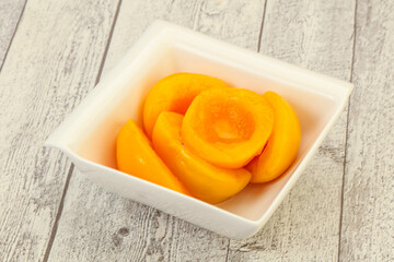 Marinated peaches fruit in the bowl