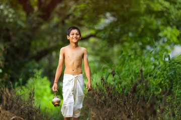 a priest child walking at forest