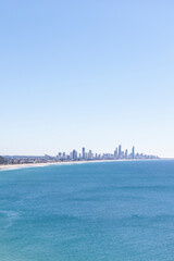 Scenic view of sea and big city against sky