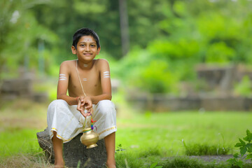 A indian priest child with holy water pot
