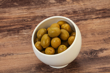 Green pickled olives in the bowl