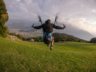 Extreme paraglider launching above Swiss Alps