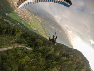 Extreme paraglider flying above Swiss Alps, Switzerland