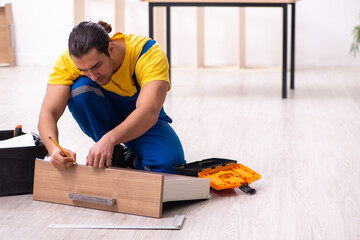 Young male carpenter working indoors