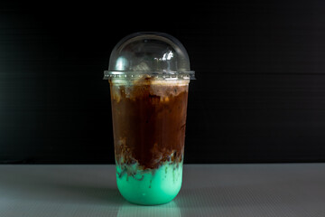 A close-up view of the drinks put into the cup, (iced tea, cocoa, chocolate) with pearls, is a popular menu in cafes and restaurants.