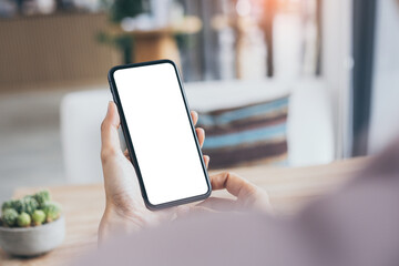 cell phone mockup blank white screen.woman hand holding texting using mobile on desk at coffee shop.background empty space for advertise.work people contact marketing business,technology