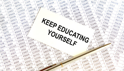 Obraz premium businesswoman holding a card with text KEEP EDUCATING YOURSELF.