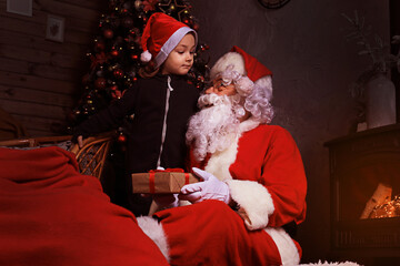 Santa Claus and child at home. Christmas gift. Family holiday concept.