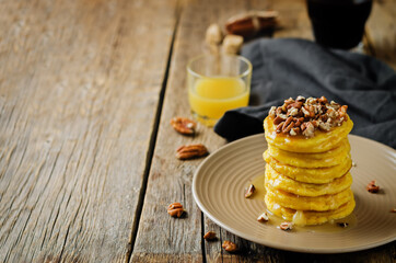 Pumpkin pancakes with pecans in a plate