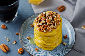 Pumpkin pancakes with pecans in a plate