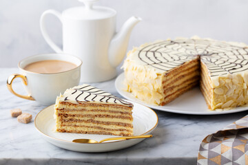 Traditional Hungarian Esterhazy cake, torte with cup of coffee. Marble background. Close up. - obrazy, fototapety, plakaty