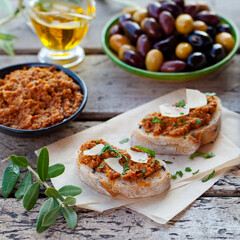 Ciabatta bread crostini, bruschetta with olive tapenade. Wooden background. Close up.