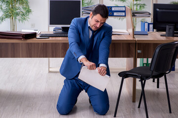 Fototapeta na wymiar Young male employee businessman at workplace