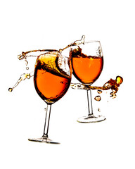 Broken wine glasses with wine splashes on a white background