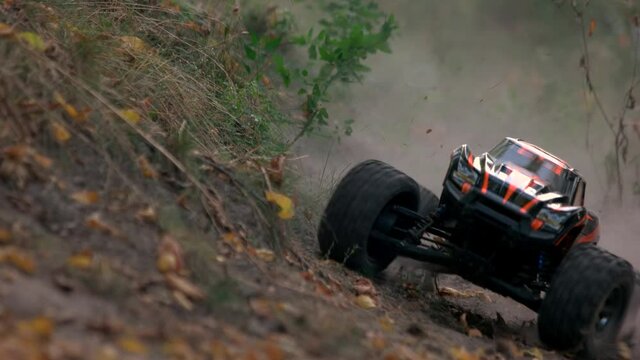 Monster truck rc car rides off-road. Fast ride on the wild grass.