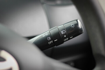 Switch off lights in a car. close-up Car integrated turning indicator with headlight switch toggle.