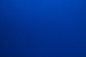 Blue background. Sheet of blank blue paper with texture, close up.