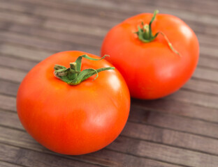ripe appetizing rispentomatoes tomatoes on wooden table