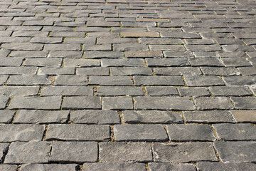 Perspective view of cobbled stone road. Paving stones on the square of the city.