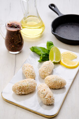 Top view of brown salmon cutlet in cheese breading
