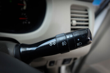 Switch off lights in a car. close-up Car integrated turning indicator with headlight switch toggle.