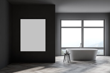 Stylish gray bathroom interior with tub, poster and windows