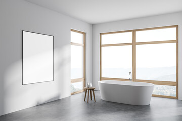 Modern white bathroom corner with tub, poster and windows