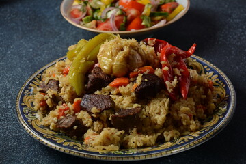 Uzbek cuisine (food) pilaf (plov palov osh) salad achichuk (achuchuk).Mutton,rice,carrots,vegetable oil,raisins,onion,turmeric,black pepper,cumin