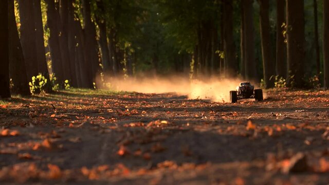 RC monster car drives fast and making thick smoke. Offroad race competition in the woods.