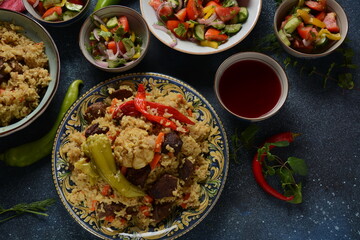 Uzbek cuisine (food) pilaf (plov palov osh) salad achichuk (achuchuk).Mutton,rice,carrots,vegetable oil,raisins,onion,turmeric,black pepper,cumin