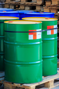 Green barrels with label poison on wooden pallets