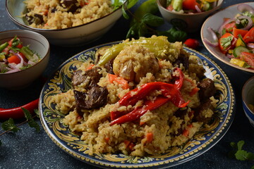 Uzbek cuisine (food) pilaf (plov palov osh) salad achichuk (achuchuk).Mutton,rice,carrots,vegetable oil,raisins,onion,turmeric,black pepper,cumin